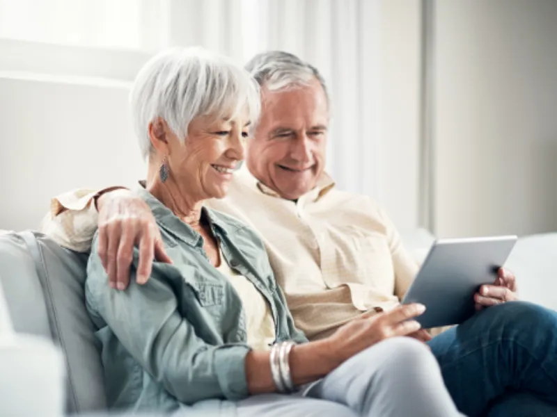 An elderly couple using a tablet