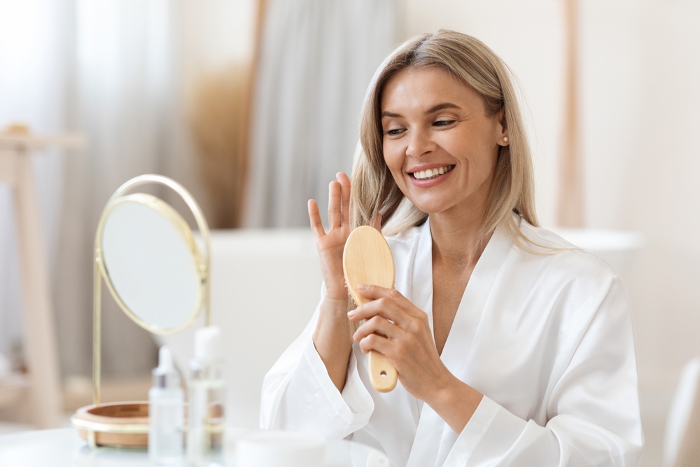 Happy woman brushing her hair